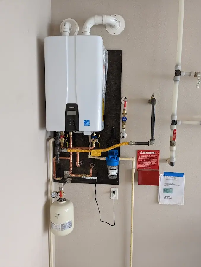 Professional plumber installing copper piping in a Richmond home